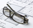 glasses of architect on drawing board