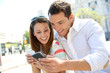 Couple of tourists in Madrid using smartphone
