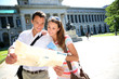 Couple reading city map in front of Prado museum, Madrid