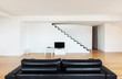 Interior, beautiful loft, hardwood floor, black divan