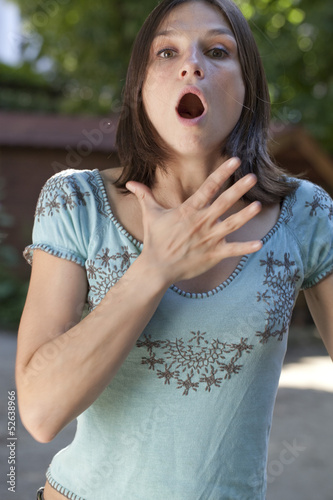 Photo: young woman suffocating or having allergies young woman suffocating or having allergies