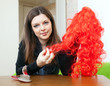  brunette woman with red false hair