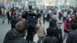 Cameraman shoots people at a crowded place.