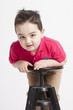 funny young boy playing in front of the camera