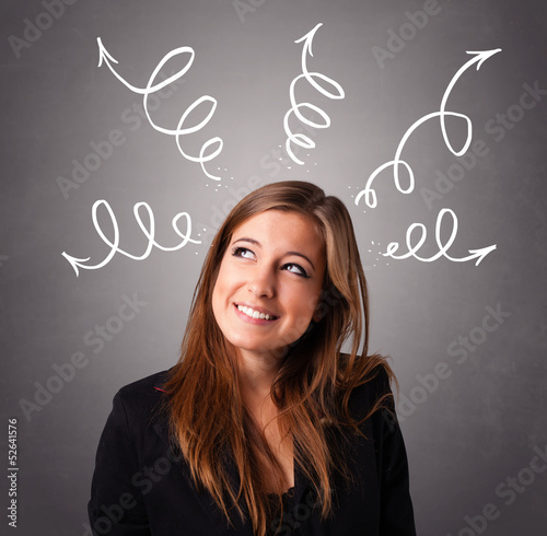 Photo: Young woman thinking with arrows overhead Young woman thinking with arrows overhead