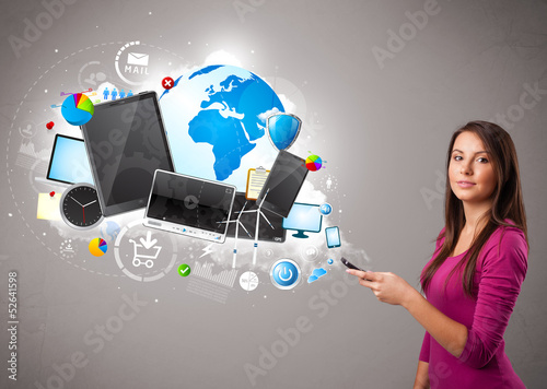 Photo: young woman standing and browsing on her phone young woman standing and browsing on her phone