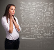 Pretty woman looking at stock market graphs and symbols