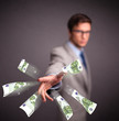 Young man standing and throwing money