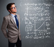 Handsome school boy thinking about complex mathematical signs
