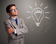Young boy comming up with a light bulb idea sign