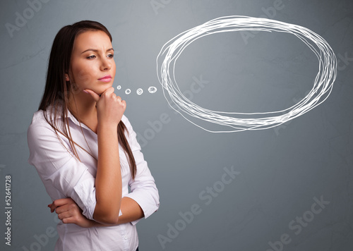 Photo: Young lady thinking about speech or thought bubble with copy spa Young lady thinking about speech or thought bubble with copy spa