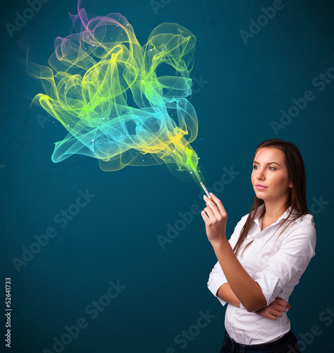 Photo: Pretty lady smoking cigarette with colorful smoke Pretty lady smoking cigarette with colorful smoke