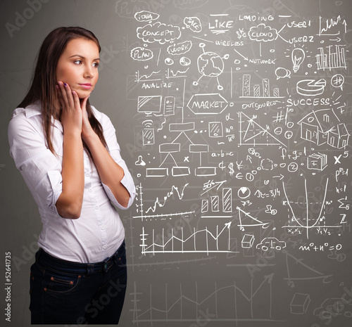 Photo: Pretty woman looking at stock market graphs and symbols Pretty woman looking at stock market graphs and symbols
