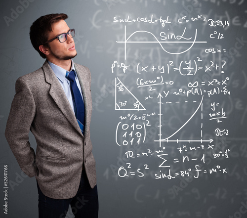 Photo: Handsome school boy thinking about complex mathematical signs Handsome school boy thinking about complex mathematical signs