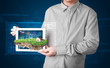 Businessman presenting a perfect ecology land with a house and w