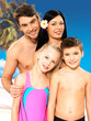 Happy family with two children at tropical beach