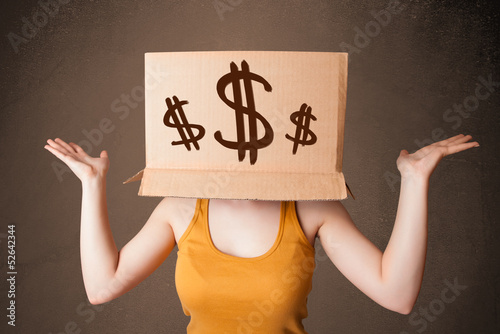 Photo: Young girl gesturing with a cardboard box on his head with dolla Young girl gesturing with a cardboard box on his head with dolla