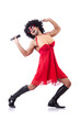 Man in female clothing singing with mic