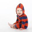Charming baby boy sitting in studio with hood