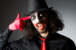Joker personification with man in dark room