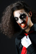 Joker personification with man in dark room
