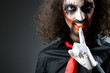 Joker personification with man in dark room