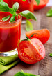 Tomato Juice and Fresh Tomatoes with Basil on a Wooden Table