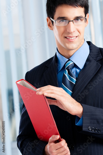 Photo: Young businessman with red folder Young businessman with red folder