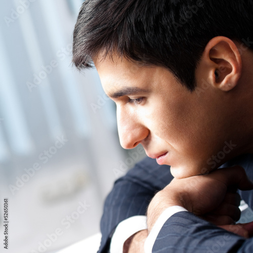 Photo: Thinking businessman at office Thinking businessman at office
