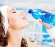 Woman drinking water, at fitness club