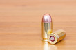 9 mm or .357 bullet on wooden background