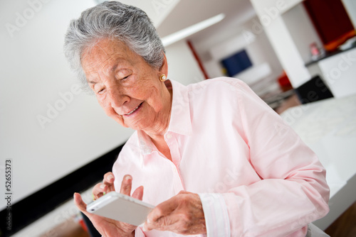 Photo: Woman using app on cell phone Woman using app on cell phone