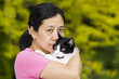 Photo: Mature woman holding large family cat outdoors Mature woman holding large family cat outdoors