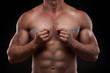 bodybuilder with a measuring tape around his chest