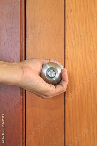 Photo: Hand opening the door Hand opening the door