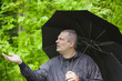 Foto: Man with umbrella in park Man with umbrella in park