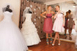 Two girlfriends Having fun in bridal Boutique