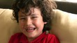 Adorable little boy smiles for the camera.