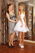 Two girlfriends Having fun in bridal Boutique