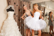 Two girlfriends Having fun in bridal Boutique