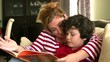 Mother and little boy reading a book together
