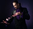 Young brunette magician in stage costume 