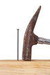 Hammer and nail with wooden board