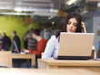 Pensive young beautiful businesswoman sitting at desk