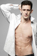 Photo: Handsome man in white shirt on gray. Handsome man in white shirt on gray.