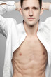 Photo: Handsome man in white shirt on gray. Handsome man in white shirt on gray.