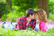 beautiful young couple in love lying in spring grass