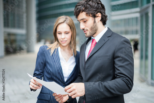 Photo: Business people reading a document Business people reading a document