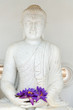 Buddha image statue with fresh flowers
