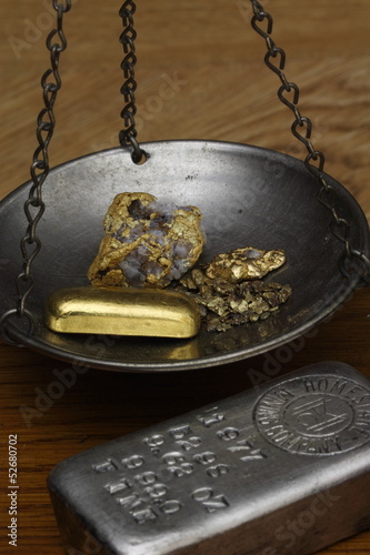 Photo: Gold Nuggets & Gold Bar on Balance Scale - Silver Ingot Beside Gold Nuggets & Gold Bar on Balance Scale - Silver Ingot Beside